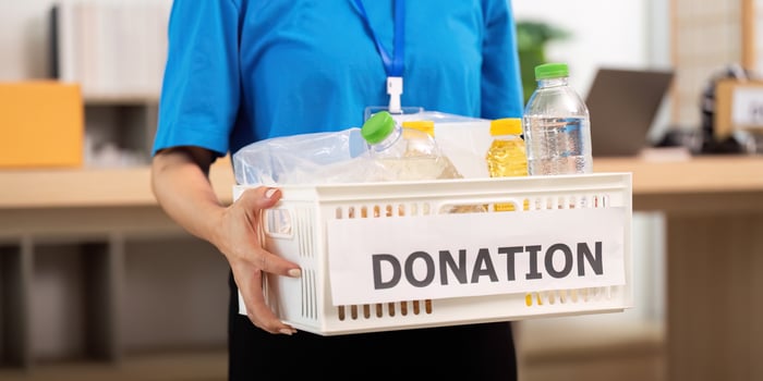 Dedicated volunteer carrying a donation basket with essential supplies photo
