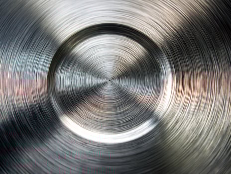 Abstract close-up of concentric metal rings with a dynamic, swirling pattern photo