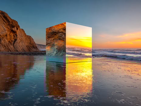 Surreal sunset reflection on a beach with a floating mirrored cube photo