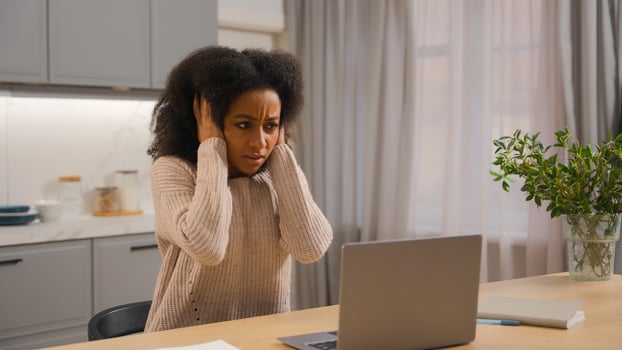 Stressed frustrated irritated African American business woman freelancer girl female trying online working studying with laptop at home upset with noisy neighbors loud close ears with hands disturb photo