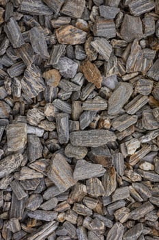Close-up of grey and brown textured rocks forming a natural surface background. Concept of geology, earth materials, construction, and nature patterns photo