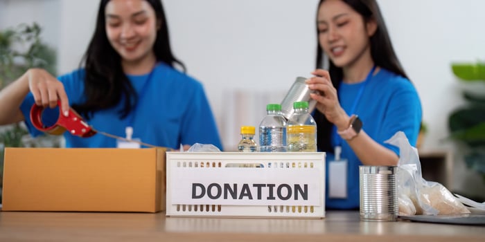 Volunteers teamwork preparing donation boxes for distribution photo