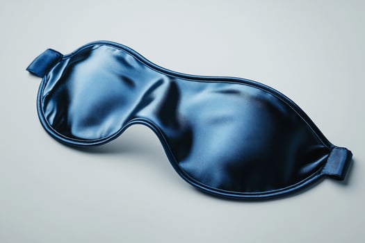 Sleep eye mask dark blue fabric for rest and relaxation isolated on plain background photo