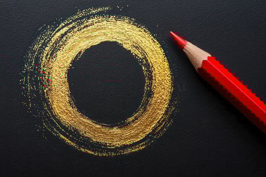 Artistic gold circle made with pencil and paint on dark textured paper photo
