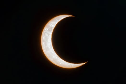 Crescent moon is in the sky with on black background photo