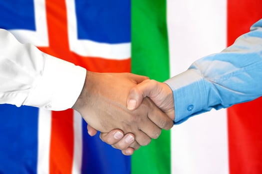 handshake on Iceland and Italy flag background. photo