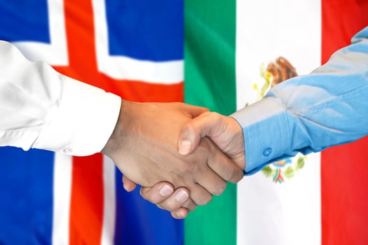 handshake on Iceland and Mexico flag background. photo