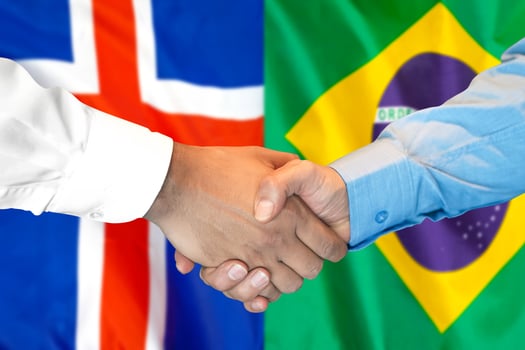 handshake on Iceland and Brazil flag background. photo
