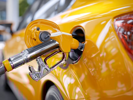 Modern yellow car being refueled at a gas station photo