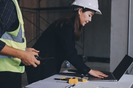 Women in hard hat using laptop photo
