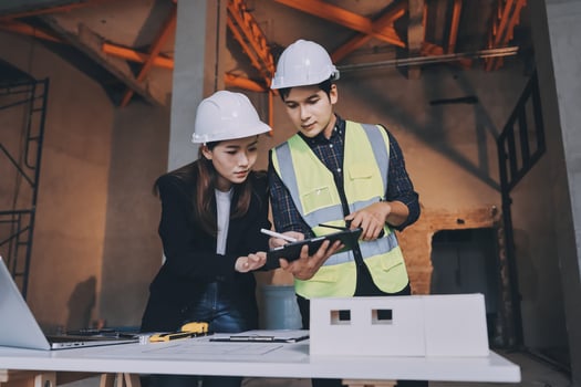 Engineers working with tablet on construction site photo
