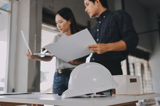 Teamworking on construction project plans photo