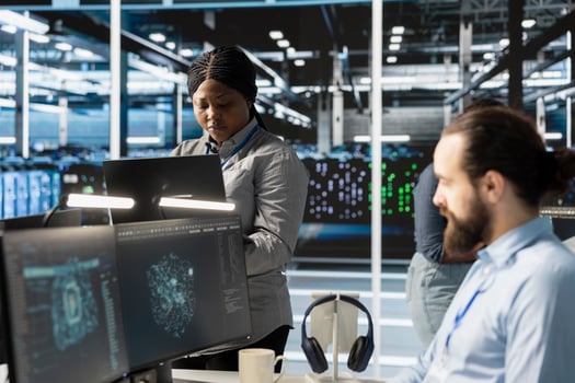 Engineers doing maintenance on blade servers supplying compute power for AI data processing and inference workloads. IT experts overseeing data center arrays managing training datasets photo