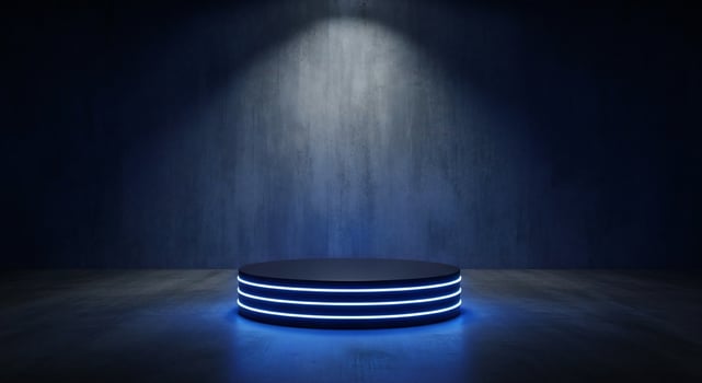 Dark stage with circular podium illuminated by blue neon lights and spotlight photo