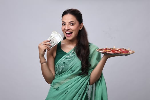 Woman with money and traditional sweets photo