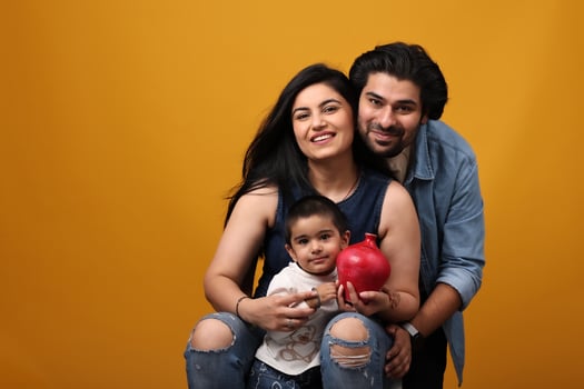 Family with a pomegranate on yellow background photo