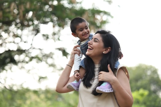 Mother carrying son on shoulders photo