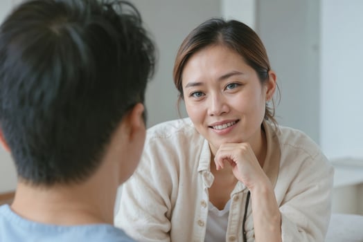 Family psychologist Asian woman talking to a client in private clinic. Asian couple at home sitting in sofa and having a talk photo