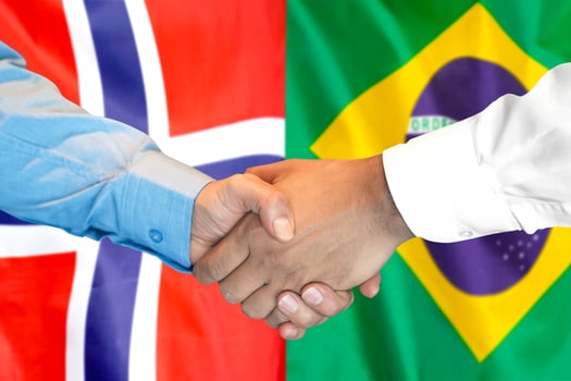handshake on Norway and Brazil flag background. photo