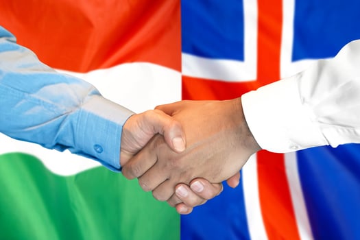 handshake on Hungary and Iceland flag background. photo