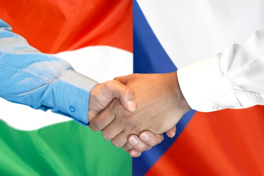 handshake on Hungary and Czech Republic flag background. photo