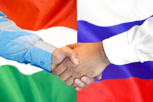 handshake on Hungary and Russia flag background. photo