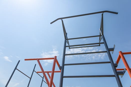 Bright outdoor fitness park features climbing structures reaching towards the sky, providing a perfect setting for active play and exercise photo