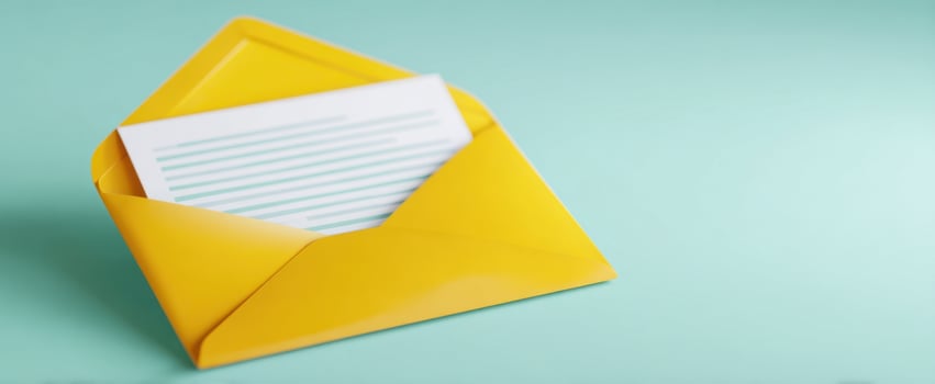 The bright yellow envelope containing a stylishly written letter on a mint background. photo