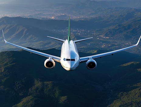 Airplane Soaring Above Majestic Mountains photo