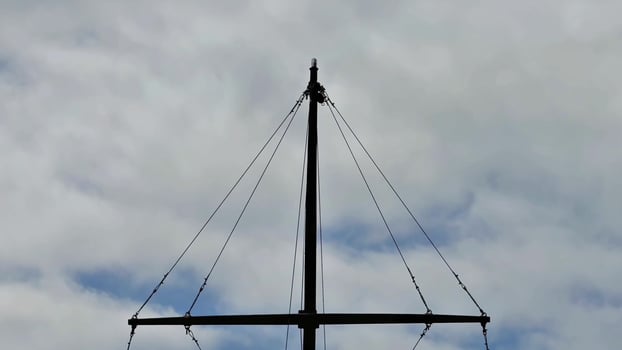 A Sailing Mast Set Against a Dramatic and Cloudy Sky in the Maritime Adventure Scene photo