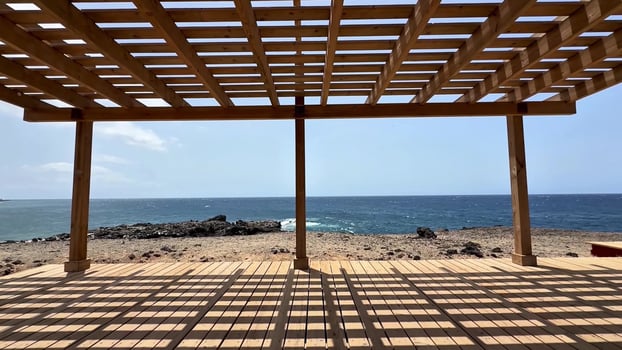 A Beautiful Seaside Structure Featuring Intriguing Shadow Play Against Its Surroundings photo