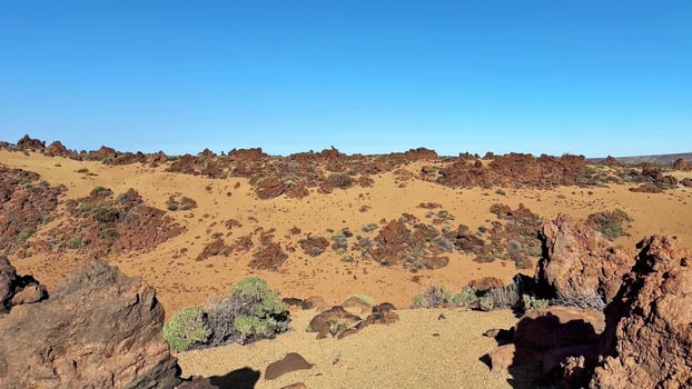 A Stunning Desert Landscape Featuring Breathtaking Rocky Formations and a Clear Blue Sky photo