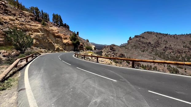 A Beautiful Scenic Winding Mountain Road with a Clear Blue Sky Above the Landscape photo