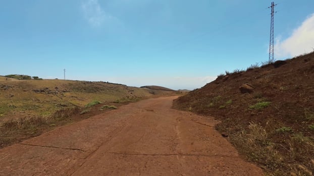 A tranquil and peaceful dirt road landscape stretches under a clear, blue sky above photo