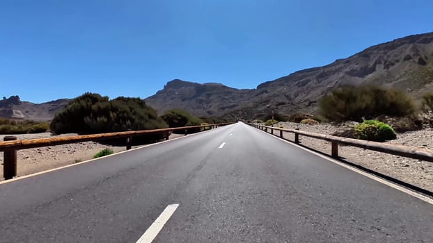 A stunning road winds through a beautiful desert with a breathtaking mountain backdrop photo