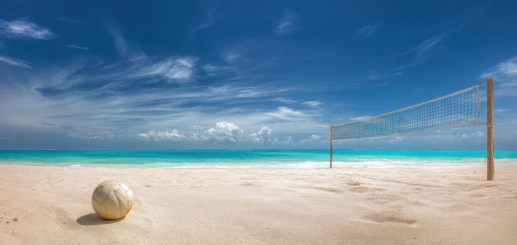 The Beach Volleyball Scene Under a Clear Blue Sky and Gentle Waves photo