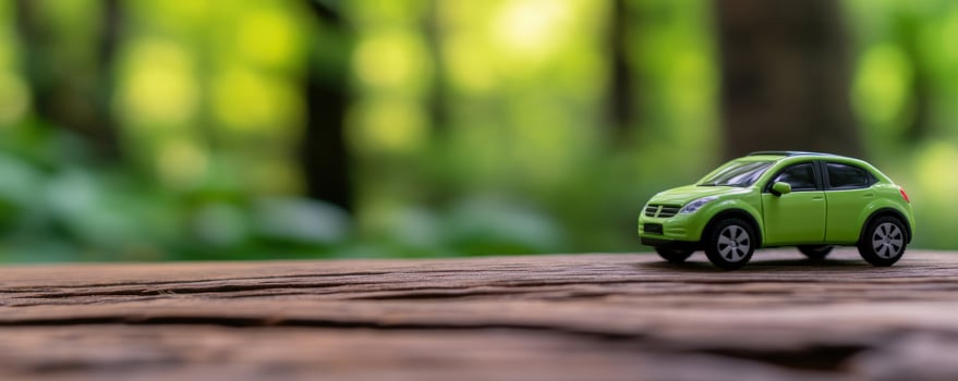 EcoFriendly Journey A Green Toy Car on Wooden Surface photo