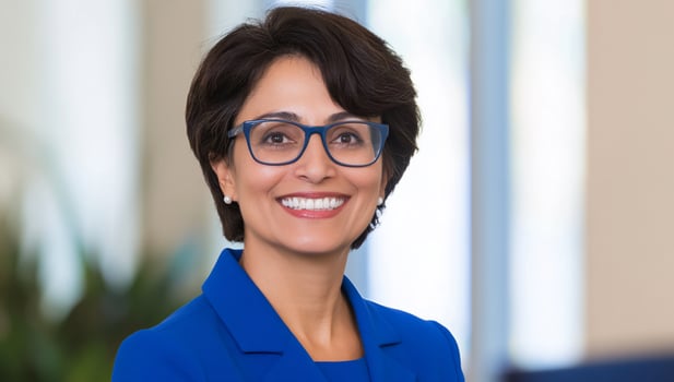 Confident woman smiling, headshot, office background, professional portrait photo