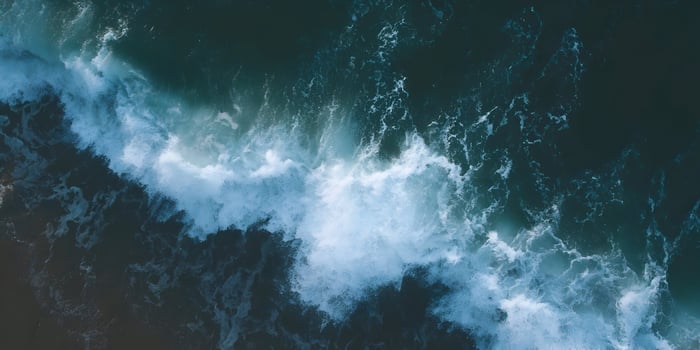 Ocean wave crashing on beach aerial view photo
