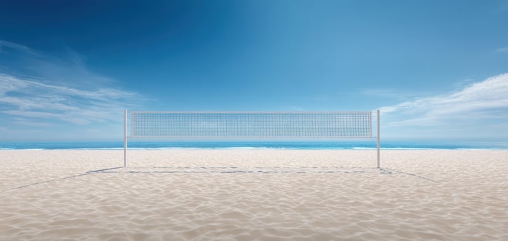 The volleyball net on a serene beach with clear blue skies. photo