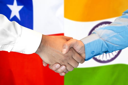 handshake on Chile and India flag background. photo