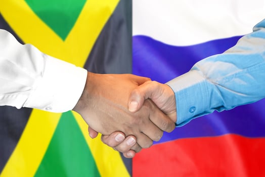 handshake on Jamaica and Russia flag background. photo