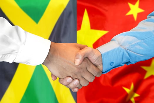 handshake on Jamaica and China flag background. photo