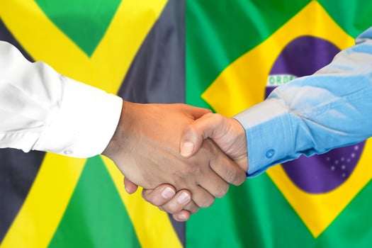 handshake on Jamaica and Brazil flag background. photo