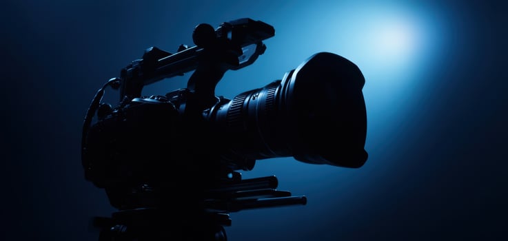 The Camera Silhouette Against a Soft Blue Background in a Creative Studio Setup photo