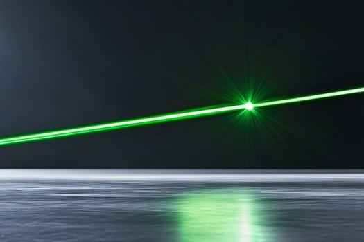Green laser beam across dark reflective floor photo