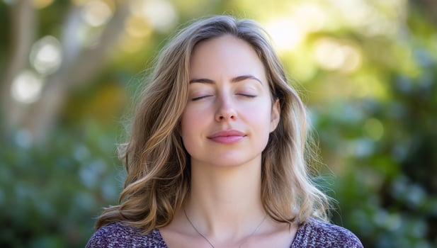 Woman meditating outdoors, peaceful park, nature background, wellness photo
