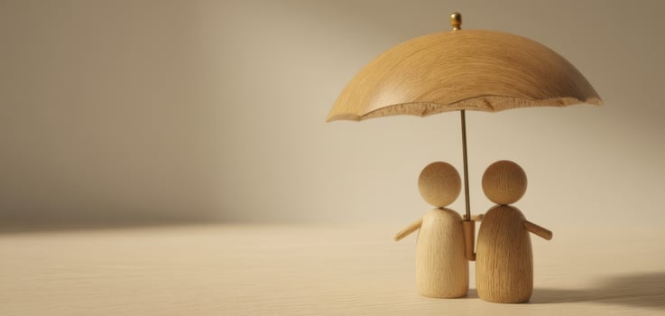 The wooden couple sharing an umbrella under soft lighting. photo