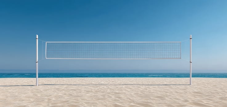 The volleyball net stands against a beautiful beach and ocean backdrop. photo