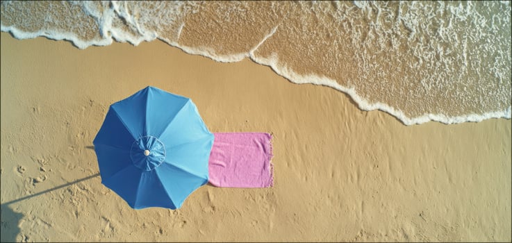 The blue umbrella providing shade on a serene beach landscape. photo